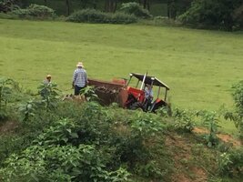 Zetor tractor on slope with Tim & Jarrah helping clean hillside of sticks 24th Apr 2017.jpg